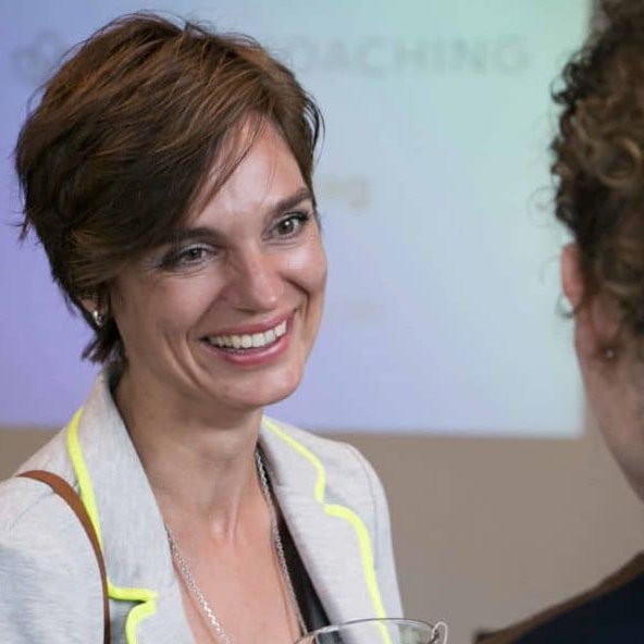 An expert psychologist in a friendly conversation with a client.